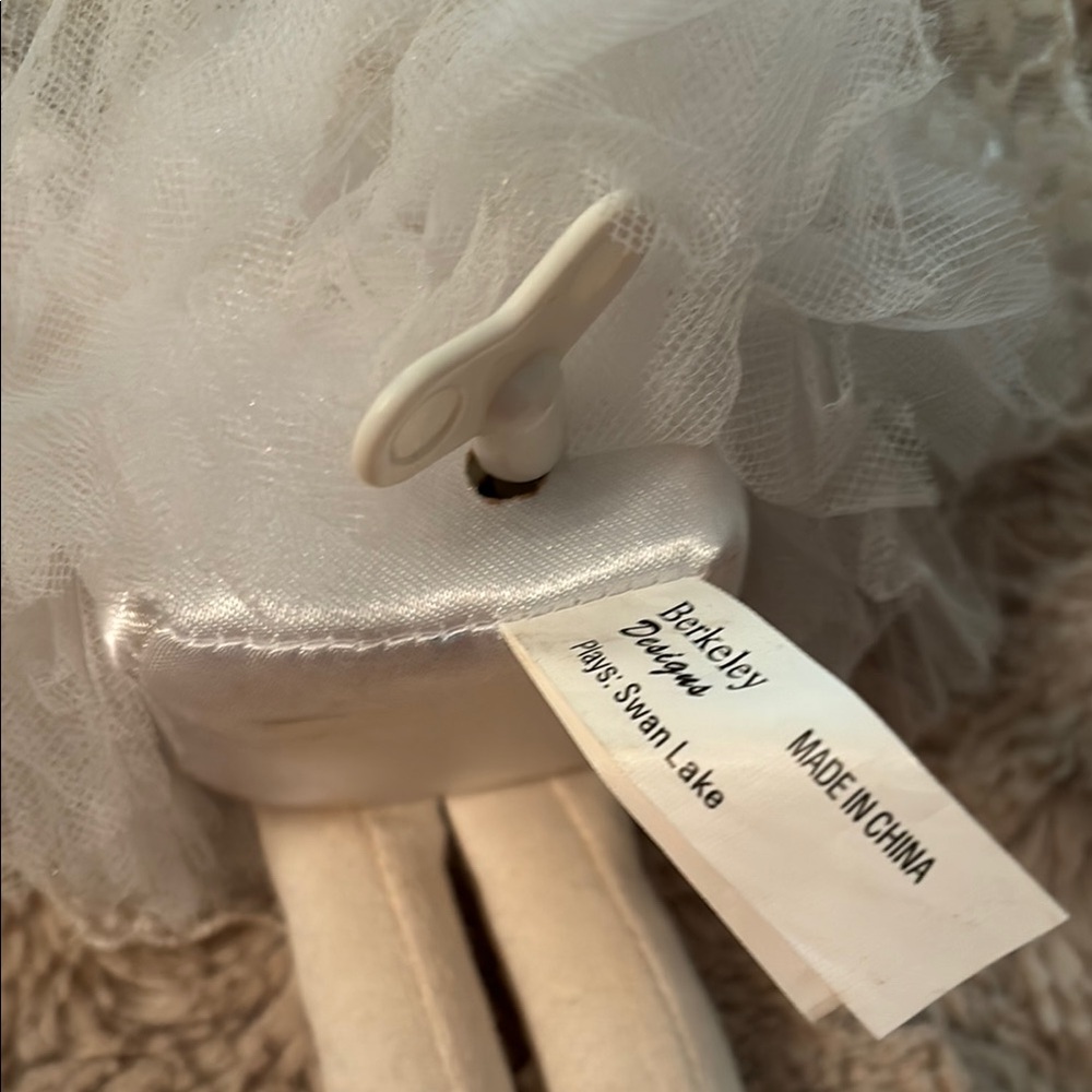 Sitting winde up ballerina. Plays Swan Lake